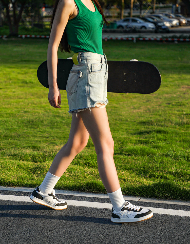 stq-logo-sneakers-banner-mobile-women-walking-with-skateboard